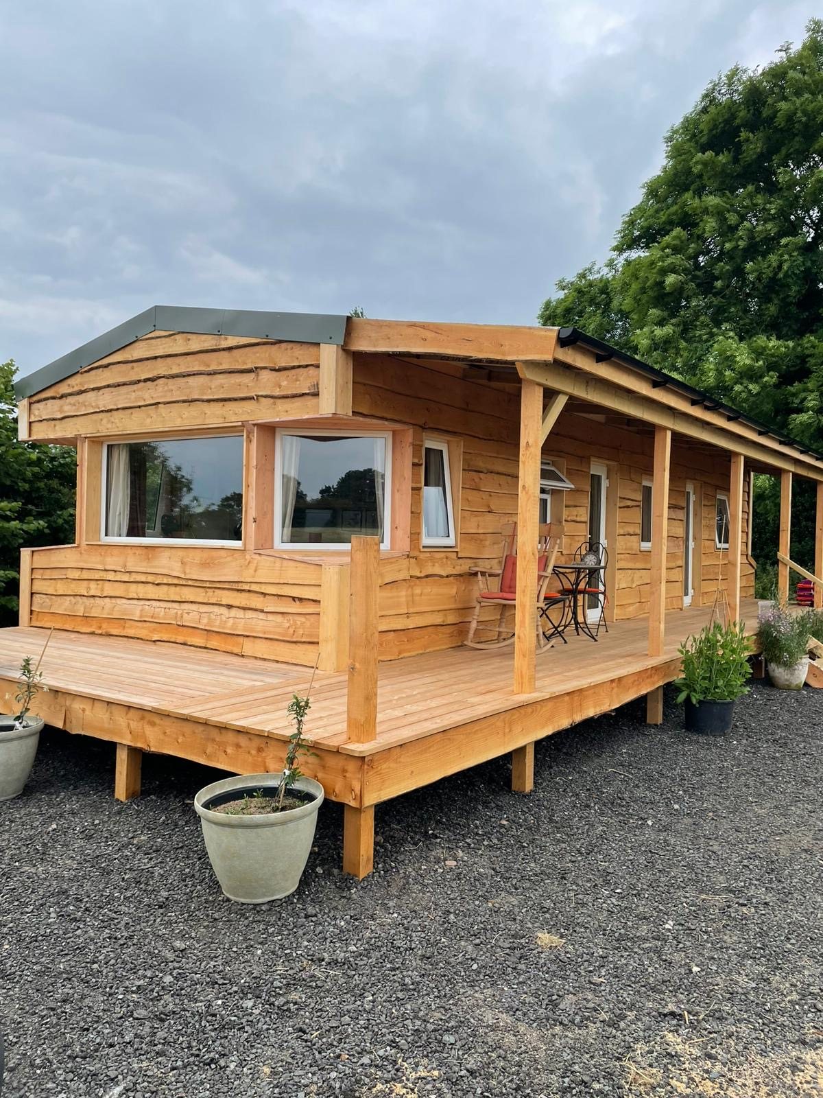 Timber-clad garden room with a raised deck, used as a home office