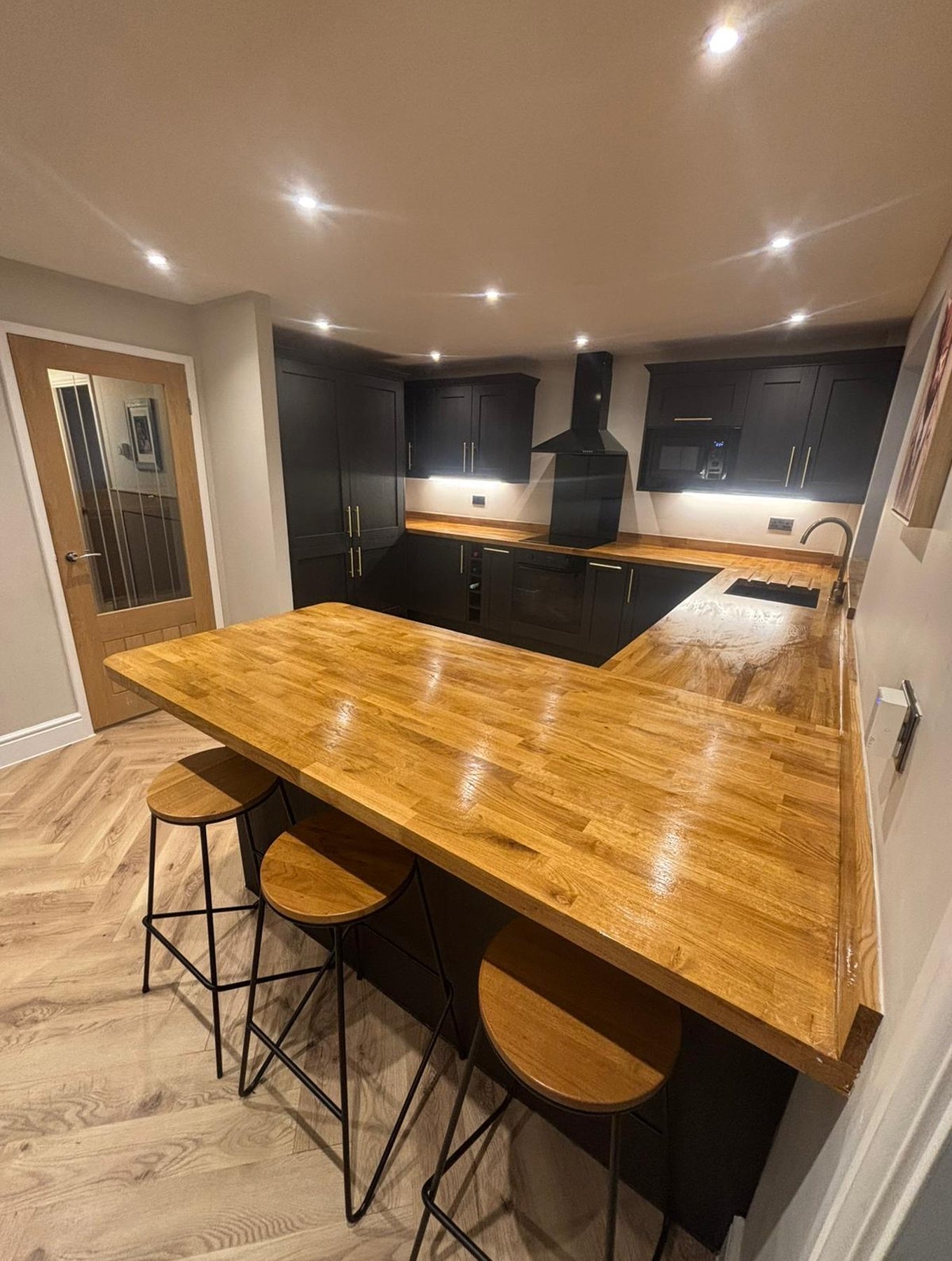 Bespoke fitted kitchen with a solid timber island and pendant lights